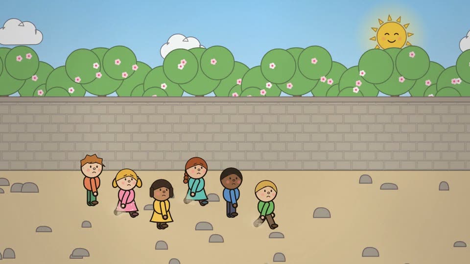 Children walk along the Selfish Giant's garden wall